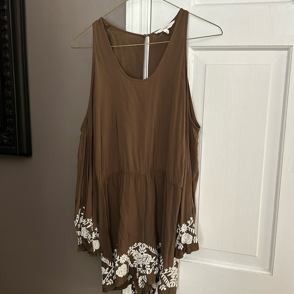 A Love Tree Romper with floral design on the bottom